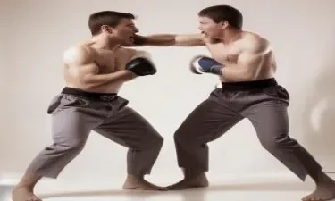 two men fighting and one is punching the other in the crotch